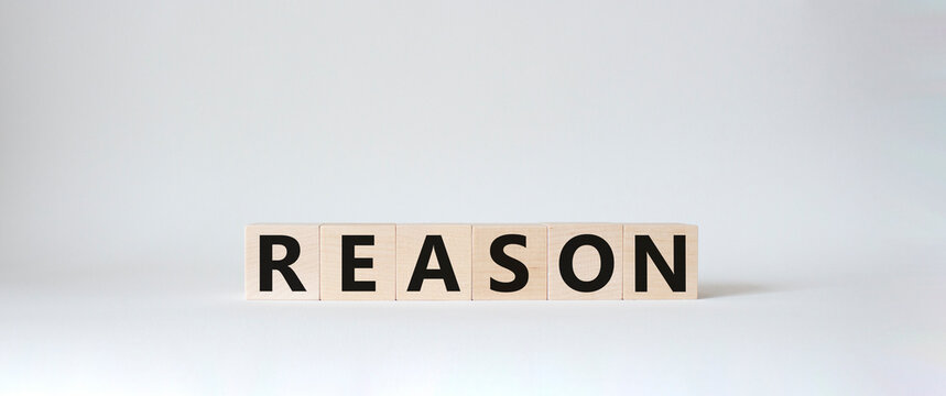 Reason symbol. Concept word Reason on wooden cubes. Beautiful white background. Business and Reason concept. Copy space.