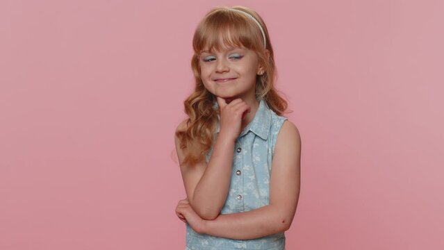 Cheerful lovely young preteen child girl kid smiling, looking at camera. Little funny toddler children schoolgirl isolated portrait alone on studio pink background. Female nature beauty. Childhood