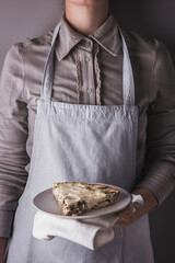A girl holding cheese casserole