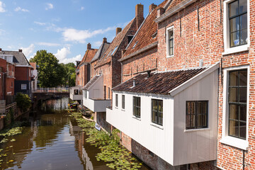 Fototapeta na wymiar Old houses with attached kitchens above the canal in the picturesque town of Appingedam in the province of Groningen; Netherlands.