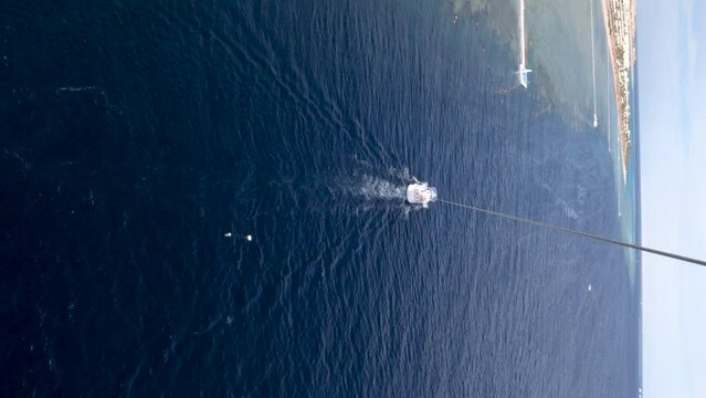 POV view of parasailing over the sea.