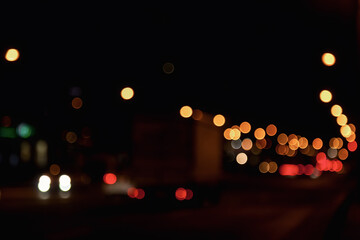 Abstract bokeh background of night street with car and street lamps