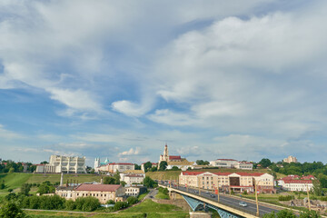 Fototapeta premium Panoramic view of the city center from above. River and bridge in the historical center of the city. movement of clouds over the city