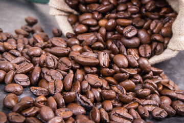 Dark roasted fragrant coffee beans in jute bag