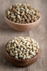 Bowl full of dried mulberry on a fabric background