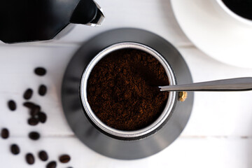 Freshly ground aromatic coffee in a geyser coffee maker. The process of making coffee in a geyser coffee maker. Top view. Close-up. Selective focus.