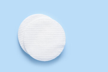 White new clean cotton pads on blue background top view flay lay