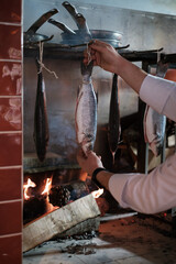 hand hung to cook fresh fish over wood fire