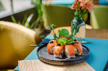 Fresh tasty sushi rolls with a salmon on the served table at the restaurant with a beautiful lightning