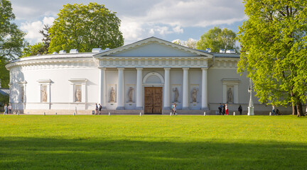 historic white building with columns on a green lawn