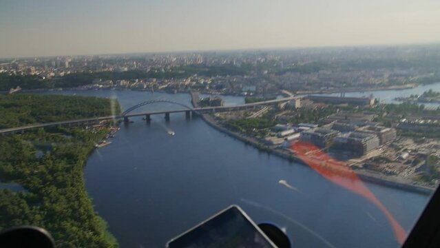 View from the window of the helicopter over the city of Kiev, water, bridges and buildings