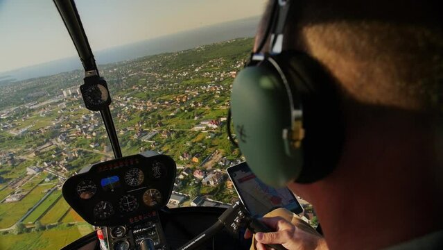 View from the cabin of the Robinson R44 helicopter. Helicopter control panel, view from the helicopter window..