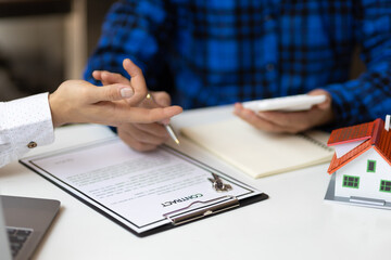 Real estate agents are discussing legal signing of home purchases, renting and mortgage agreements.