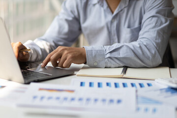 Modern business accountants are using laptops to check financial transactions using laptop...