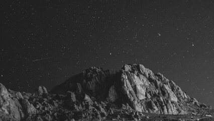 Mesmerizing shot of a landscape under the starry sky in grayscale