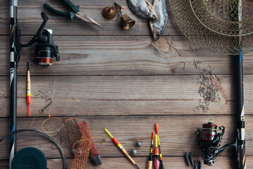 Fishing tackle background. Lifestyle. Spinning, hooks. Accessories for fishing on the wooden background. . Active hobby recreation concept. Top view, flat lay. © Oksana