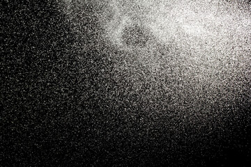 Sprayed water. Small droplets of water in the air. Lots of water drops, isolated on black background.