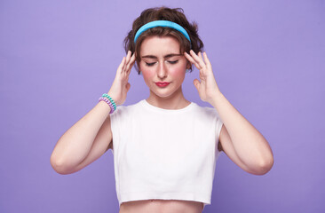 Young beautiful woman suffering from headache desperate and stressed because pain and migraine. Hands on head.