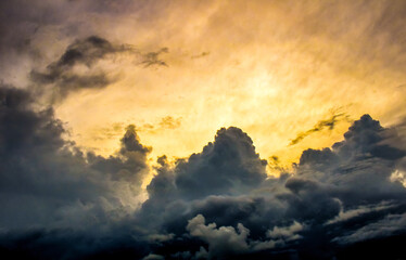 
Yellow sky with dark clouds and sunbeams