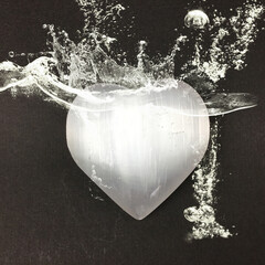 Heart shaped selenite crystal with energy aura and water splashes. Raise your vibration higher with...
