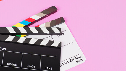 Two Black and white clapper board or movie slate on pink background. crop shot