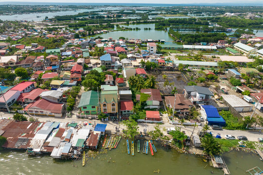 Dagupan, Pangasinan, Philippines - Boats lined along the river near a residential area. Aerial view of the city.