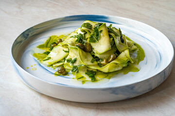 Salad Zucchini Slices with Pesto Sauce, Mint Leaves and Olive Oil.