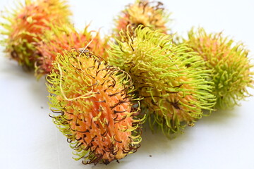 unripe rambutan fruit isolated on white background. Rambutan is a fruit found in the tropics, especially in Southeast Asia.