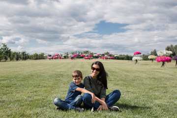 boy with mom in the field on the grass in the park