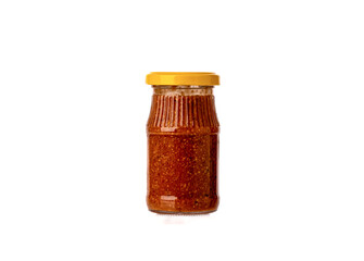 Glass jar with Bavarian mustard closed with a yellow lid on a white background.
