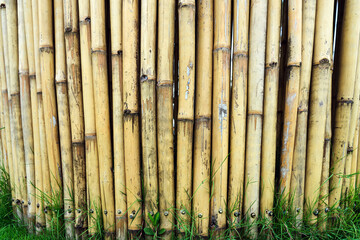Old brown tone bamboo simple wall or Bamboo fence texture background for exterior design vintage tone. Brown bamboo stick pattern backdrop. Local area urban house protection from thief.