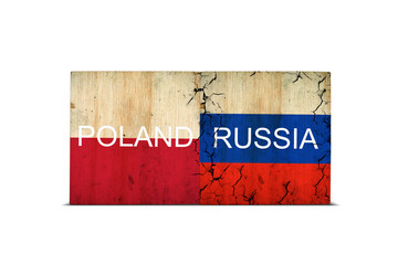 Flags of Poland and Russia on wooden blocks. Isolated on white background. Conflict between Poland...