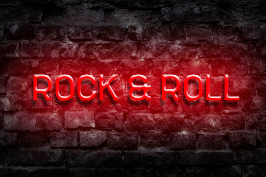 Rock and Roll.Red Neon sign on an old brick wall. Music. Style in Music. Music background.
