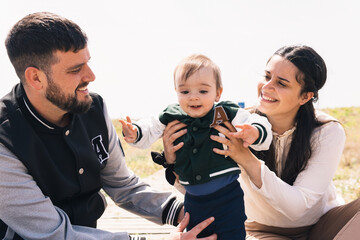 Parents playing with their son on the beach. Family concept.