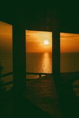 Vertical shot from a gazebo to the seascape in the sunset.