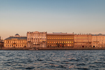Fototapeta na wymiar Sunset on the Neva river. View of the Palace embankment.