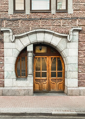 Art Nouveau wooden front door. Openwork details close-up.