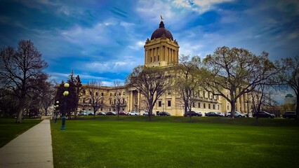 Beautiful Manitoba Legislative building with a green park and cars in front in Winnipeg, Canada