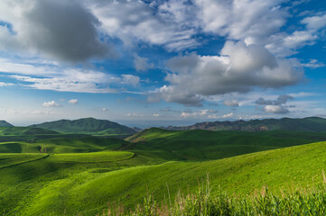 Green mountain landscape and cloudy sky. Natural background.