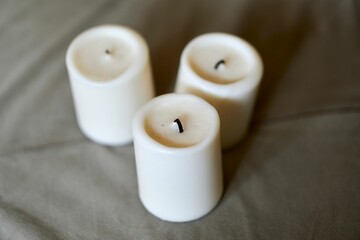 Selective focus shot of a blown candle on a gray background