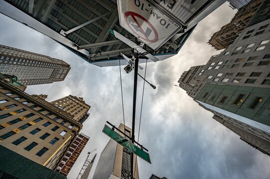 Worm's Eye View Of Buildings Under A Cloudy Sky In New York City, USA