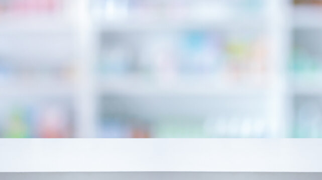 Empty white counter with pharmacy drugstore shelves blurred background