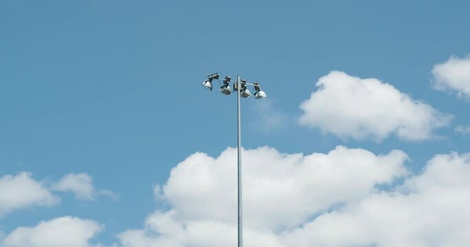 View of baseball field light post in background of sky