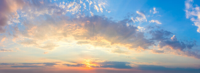Fototapeta na wymiar Gentle colors of Real sundown sunset sky with beautiful light clouds and sun