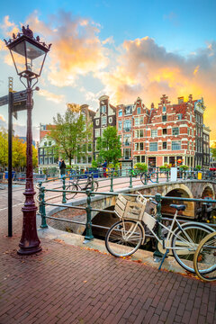 Amsterdam. Holland. Downtown of Amsterdam. Traditional houses and bridges of Amsterdam. A colorful sundown time.