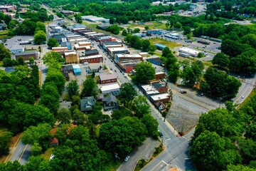 Drone shot of trees and small rural houses in the town of Elkin, North Carolina on spring day