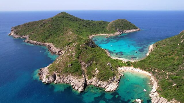 Greece Corfu Porto Timoni double beach aerial 4K drone. Unique twin bay bird eye. Crystal clear turquoise Ionian sea. Mediterranean summer travel paradise island. Afionas coastline scenery