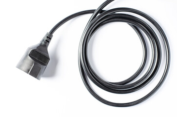 Black electric extension cord on a white background. Closeup