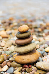 Pyramid stones balance on the beach. Calm. Zen-like concept.
