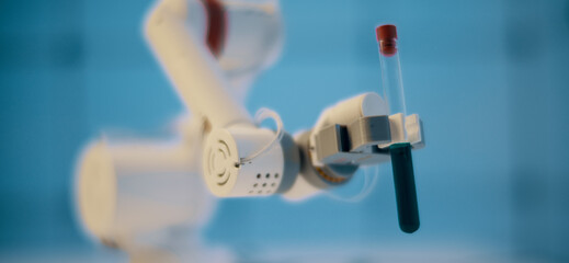 Robot take a test tube with a liquid. Laboratory of poisonous and hazardous chemicals